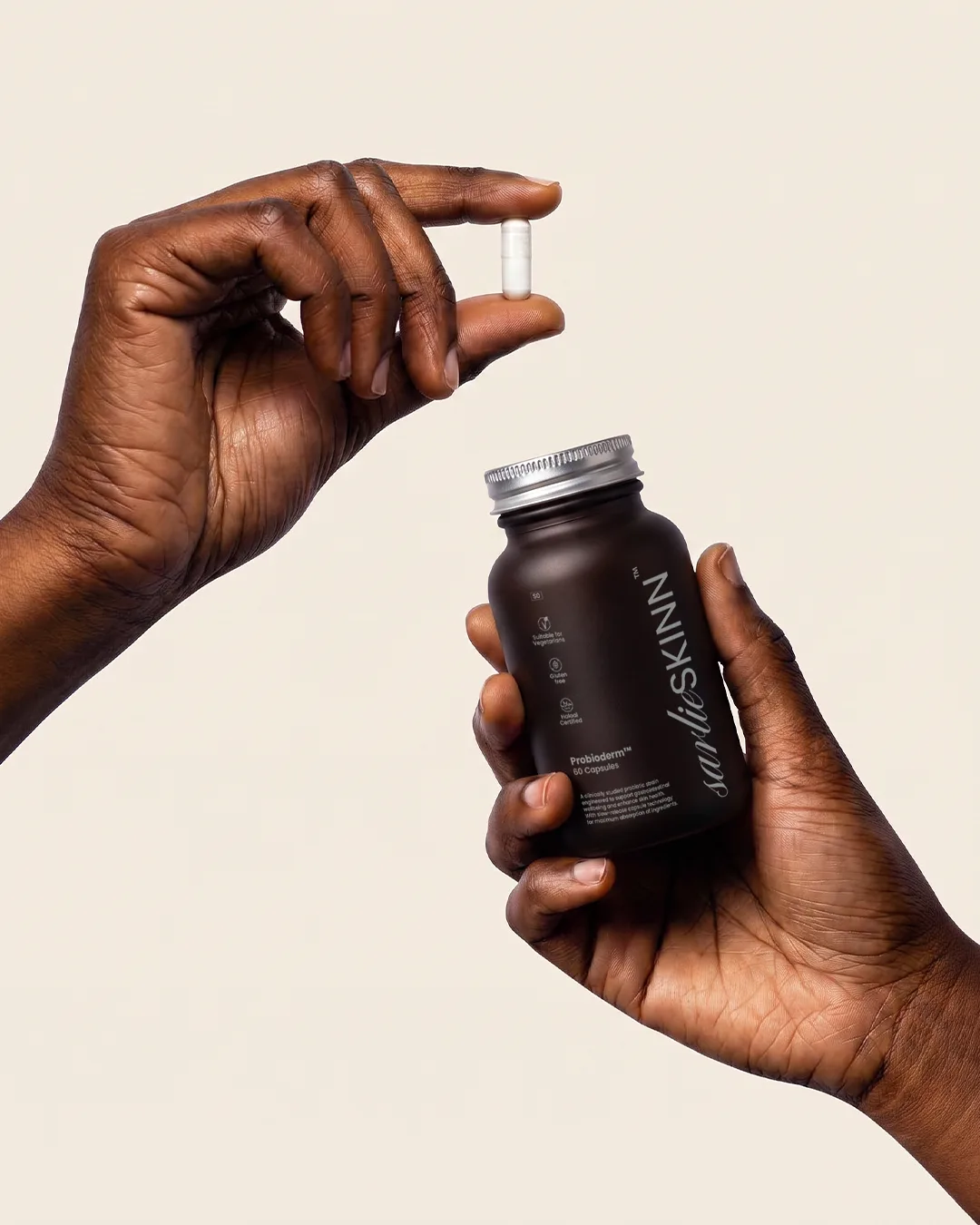 Hand holding Probioderm bottle